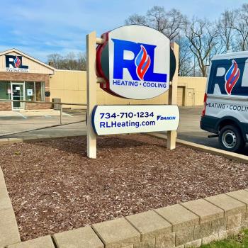 R&L Heating and Cooling sign and truck in front of our storefront in Taylor